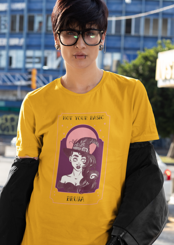 Short haired person with glasses wearing golden tee shirt